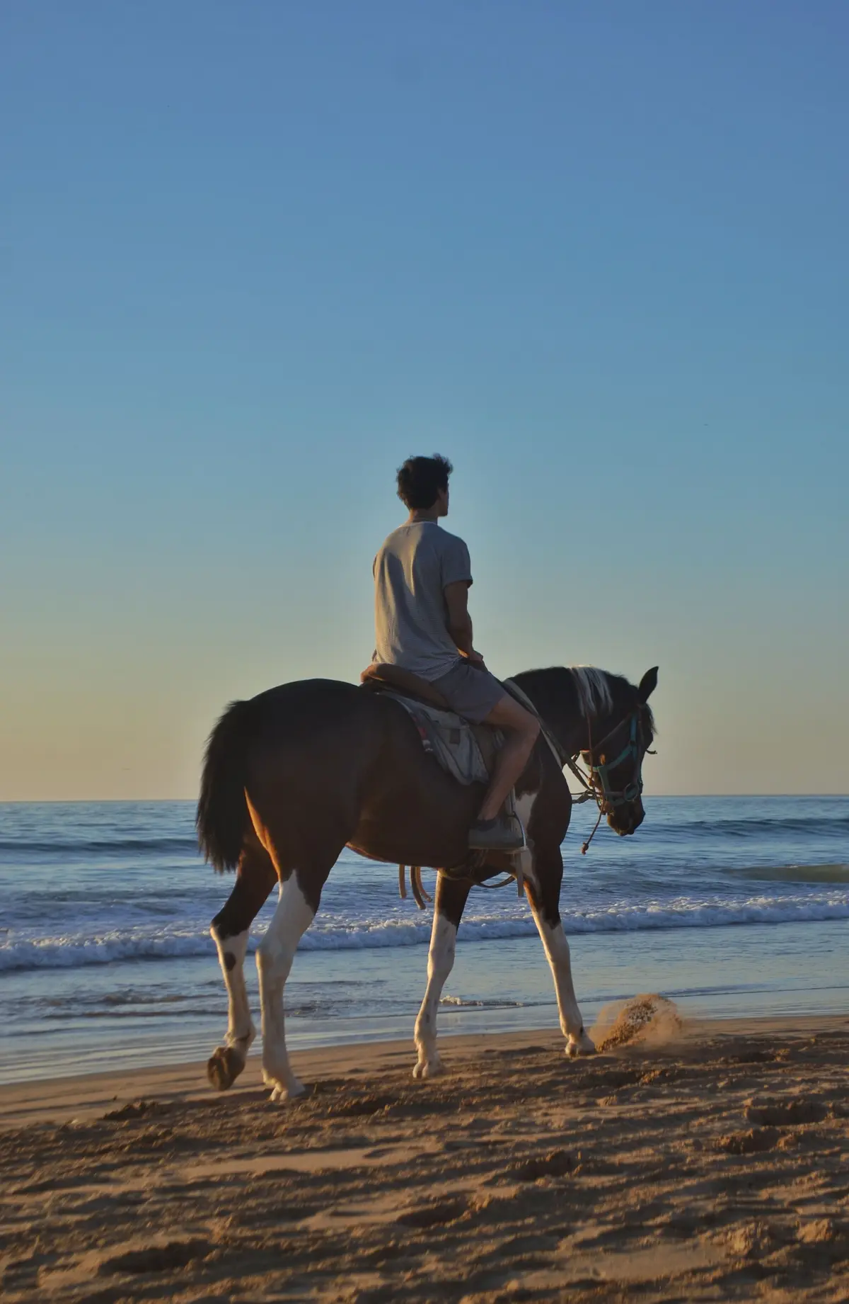 Horseback riding on white sand